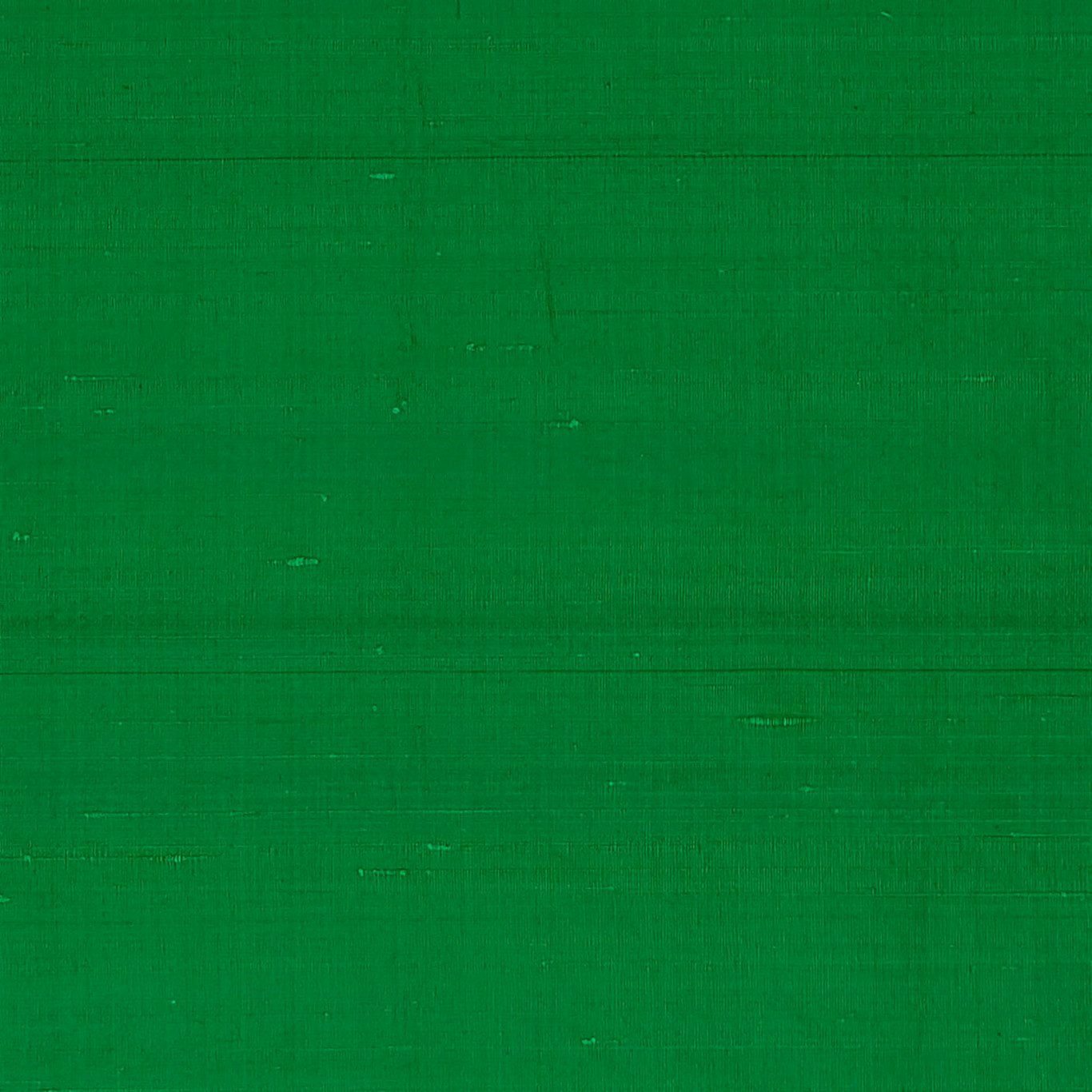 Vivid fern green textile with subtle slubbed weave and fine linear texture