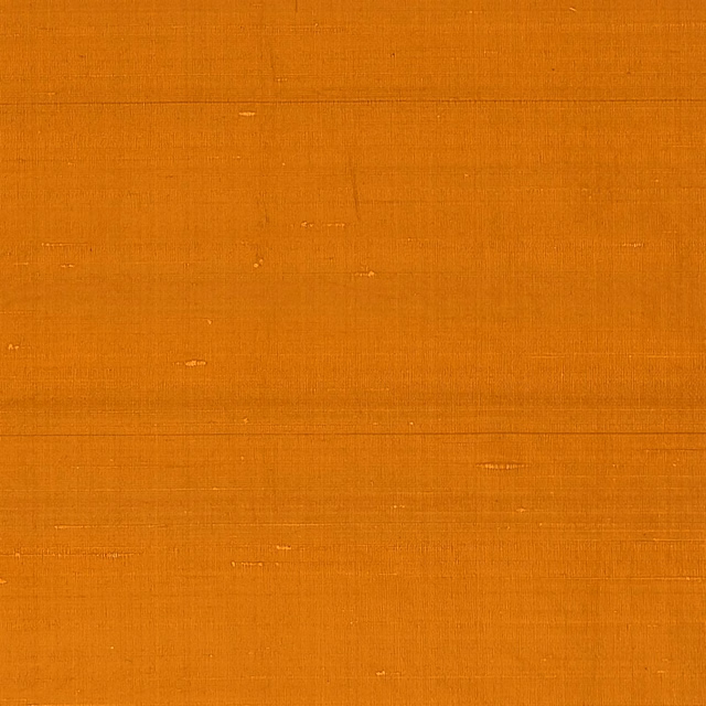 Burnt flame-orange plain weave with fine horizontal slubs and a softly textured surface