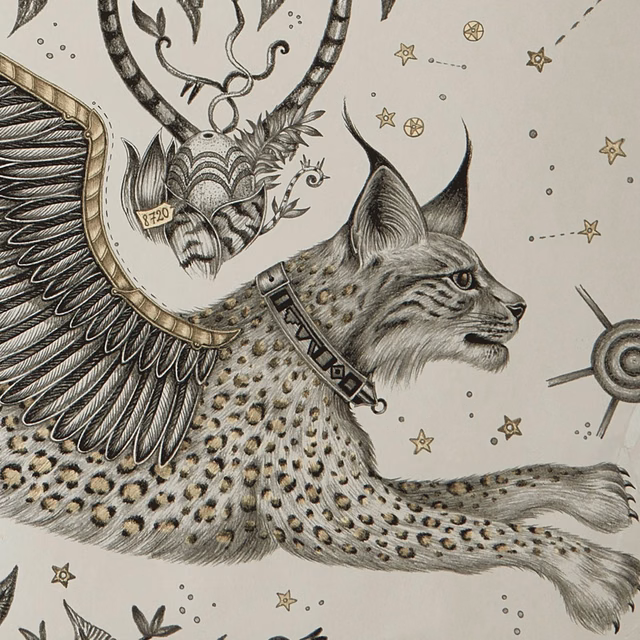 Cream wallpaper with a charcoal lynx, feathered wing and scattered muted-gold stars