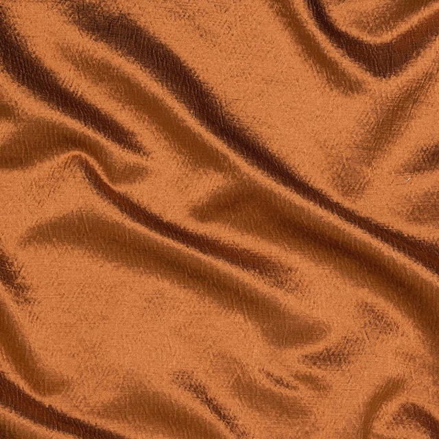 Bronze-copper fabric with soft sheen and rippling folds