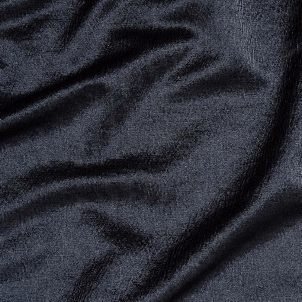 Wrinkled charcoal-black woven fabric with a subtle textured sheen