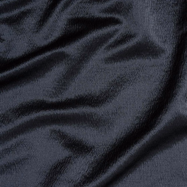 Wrinkled charcoal-black woven fabric with a subtle textured sheen