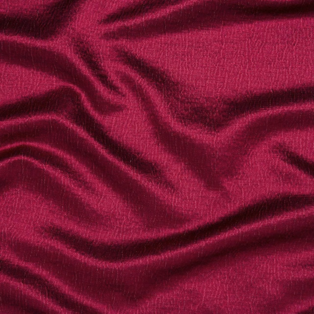 Deep fuchsia pink fabric with a fine woven texture and soft draped folds