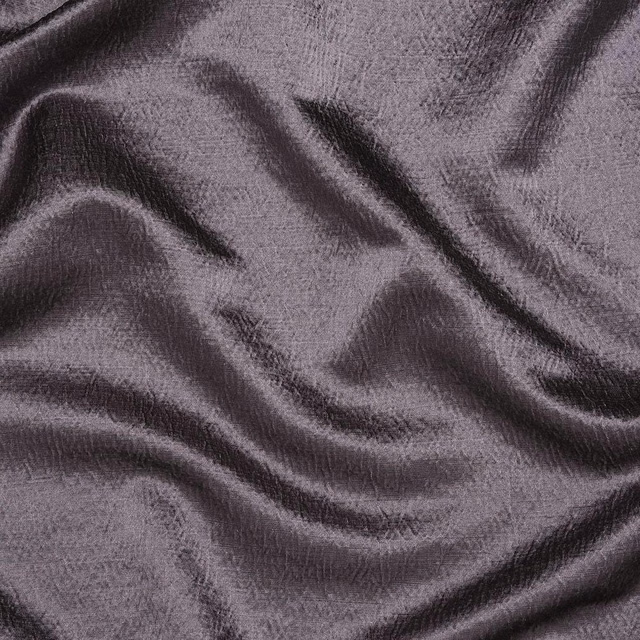 Close-up of dusty mauve fabric with subtle sheen and soft rippled texture
