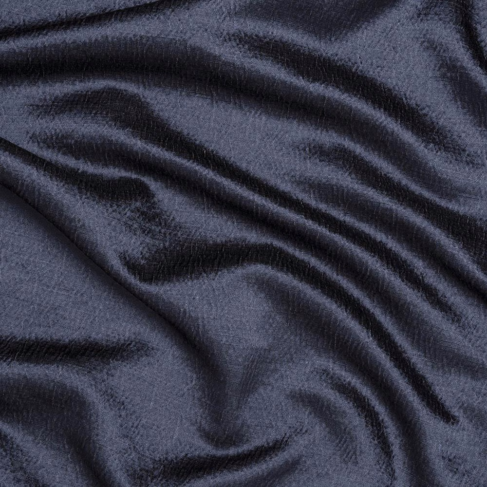 Close-up of deep navy woven fabric with soft lustre and rippling folds