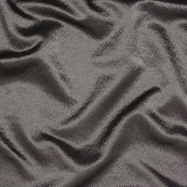 Pewter grey textured fabric with dark shadowed folds and soft sheen