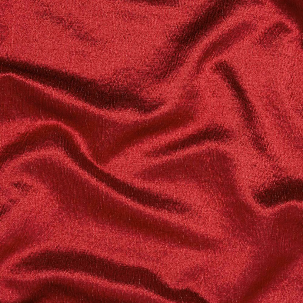 Close-up of deep crimson red woven fabric with a subtle sheen and soft folds