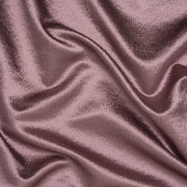 Soft dusty mauve fabric with a lustrous crinkled sheen and flowing folds