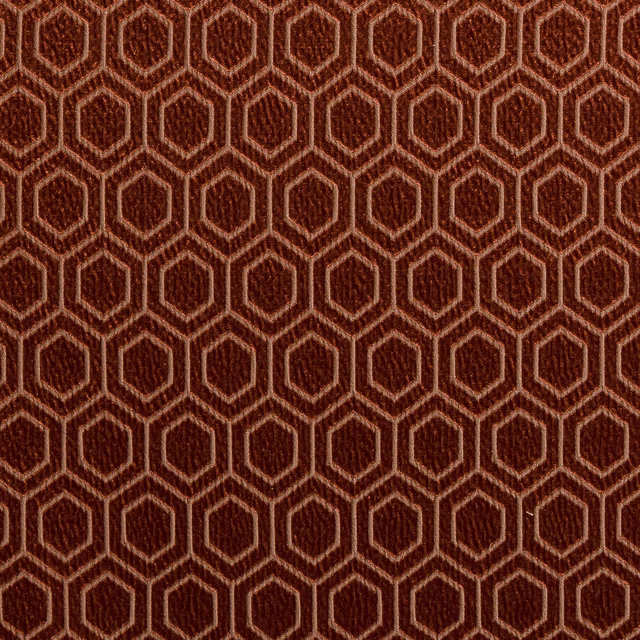 Close-up of burnished bronze hexagon weave with copper outlines on a dark ground
