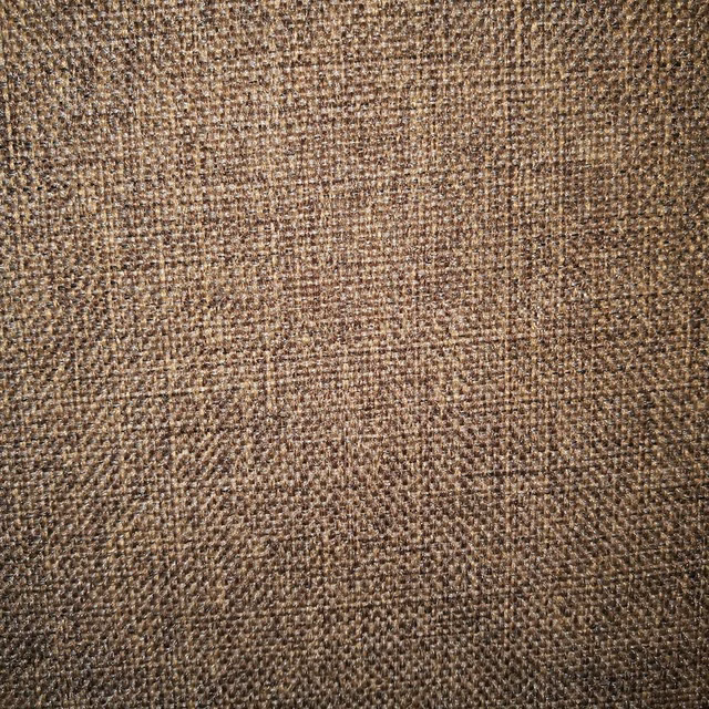 Close-up of warm chestnut brown woven fabric with a мелange texture