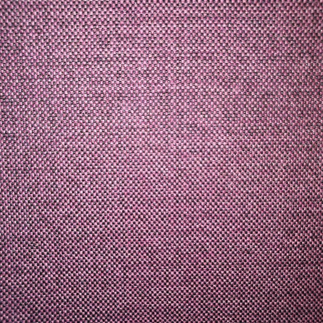 Close-up of dusty grape woven fabric with a tight textured surface
