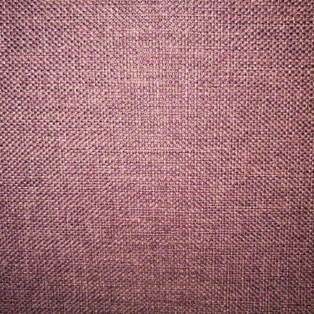 Close-up of heathered mauve woven fabric with fine pebbled texture