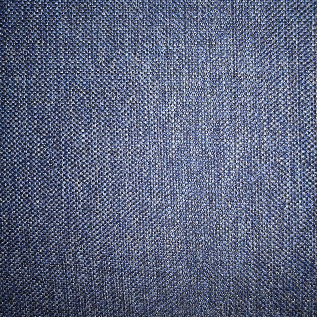 Close-up of a textured indigo-blue woven fabric with small basket weave