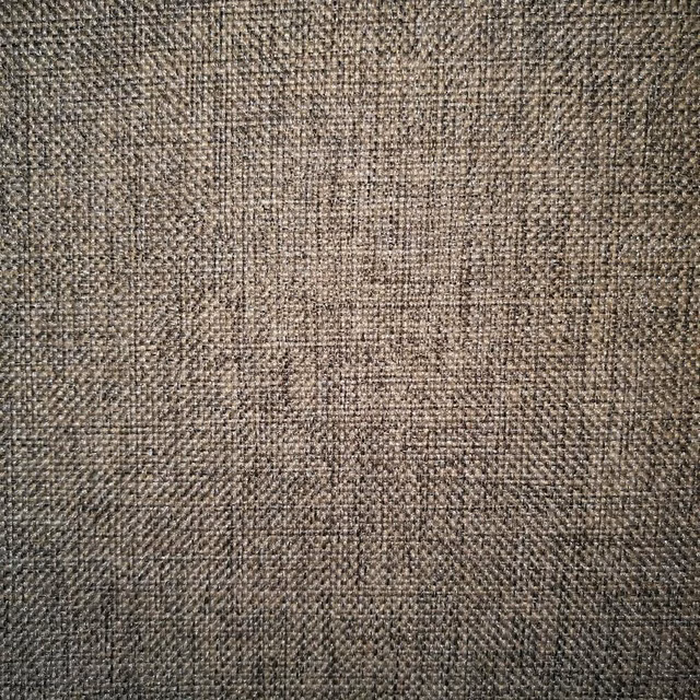 Close-up of a tightly woven slate blue-grey fabric with subtle tonal texture