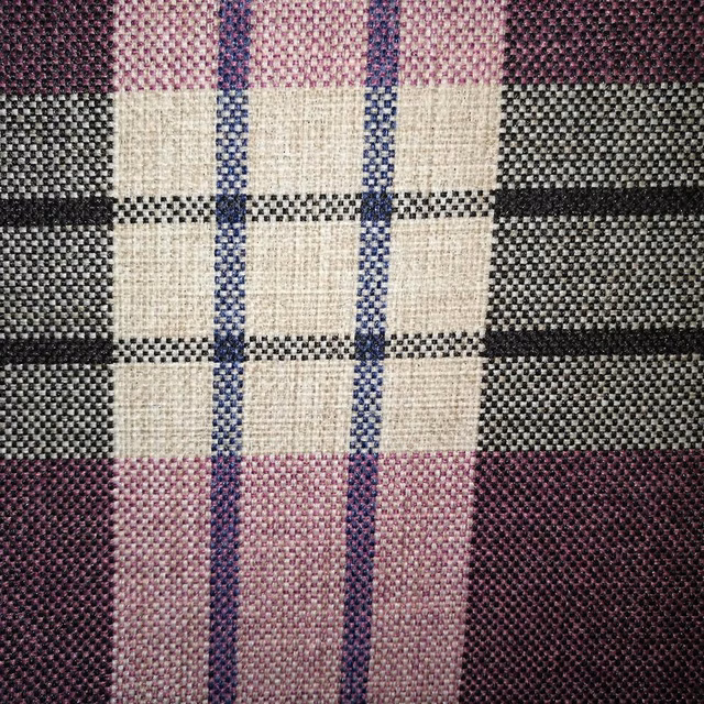 Close-up of a woven grape, cream, charcoal and pink checked fabric swatch