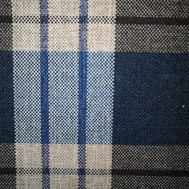 Textured woven check fabric in deep teal, navy, cream and charcoal blocks