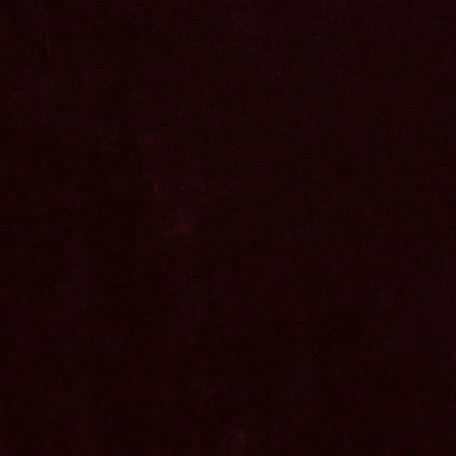 Deep mulberry fabric with a nearly black velvet-like surface texture
