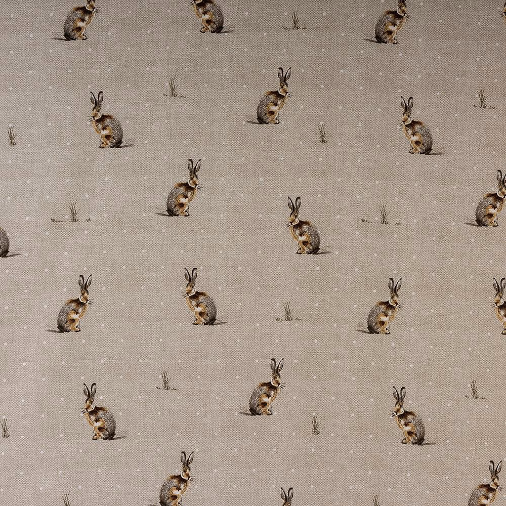 Beige cotton fabric with scattered hare motifs and tiny grass sprigs