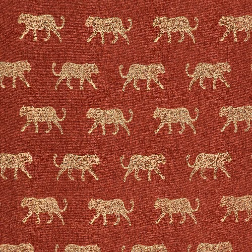 Burnt orange woven cotton with small pale leopard motifs in repeating rows