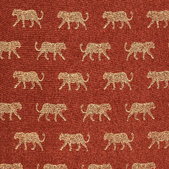 Burnt orange woven cotton with small pale leopard motifs in repeating rows