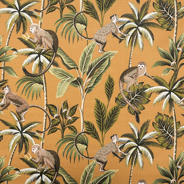 Ochre cotton fabric printed with monkeys and tropical foliage