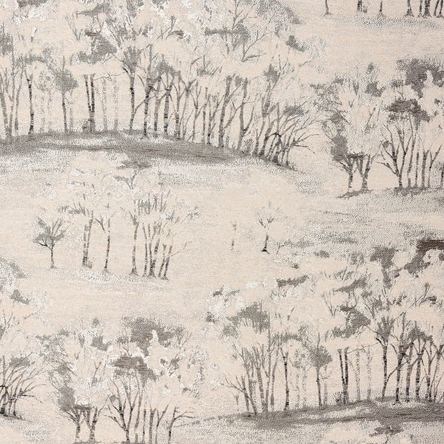Soft charcoal tree landscape print on a pale neutral fabric ground