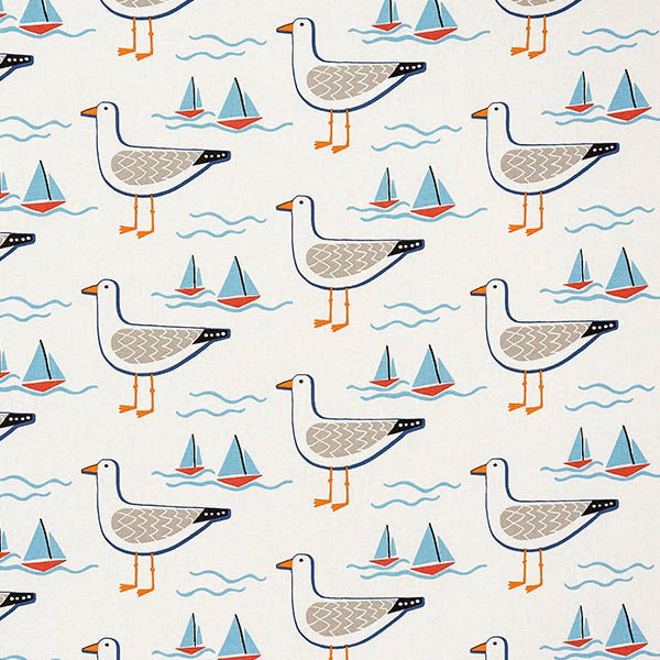 Cream cotton fabric with gulls, sailboats and wave motifs in navy, coral and turquoise