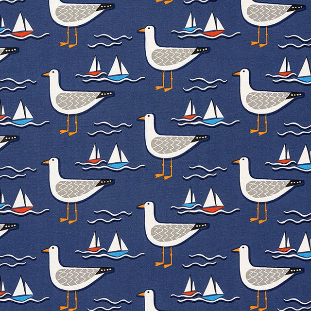 Navy cotton fabric with gulls, sailboats and waves in a coastal print