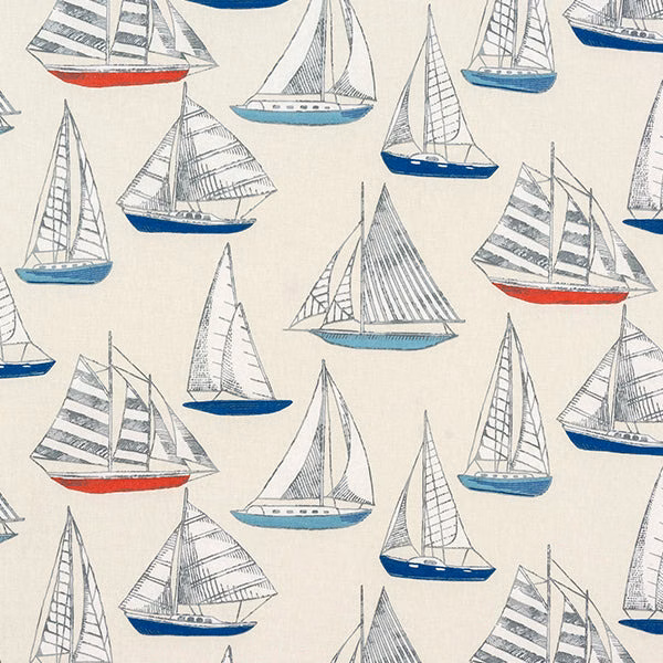 Cream cotton fabric printed with small sailing yachts in blue, grey and red