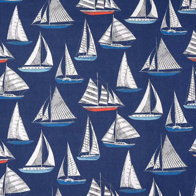 Navy cotton fabric with white sailboats, teal hulls and red accents