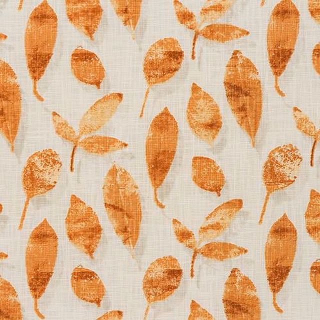 Burnt orange leaf print on pale cotton ground with a textured weave
