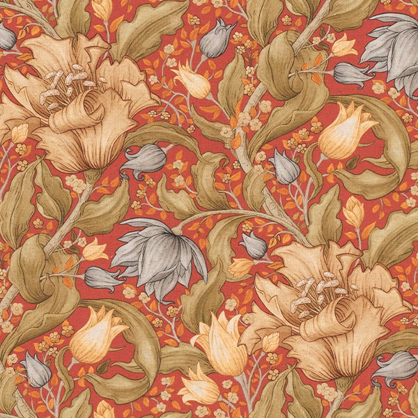 Large botanical print on warm red fabric with olive leaves and pale flowers