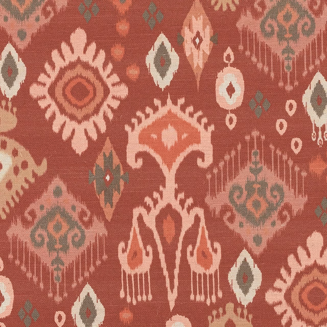 Crimson ikat-style patterned fabric with ivory and muted green motifs