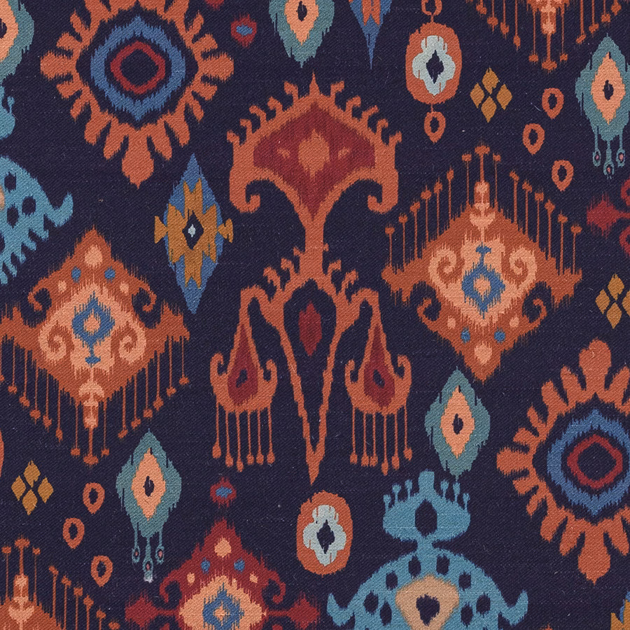 Deep indigo printed fabric with colourful geometric motifs and a woven texture