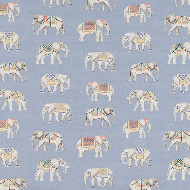 Printed cotton with ivory elephants on a soft dusty blue ground