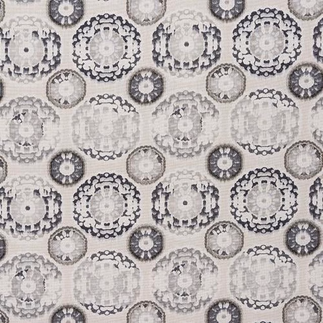 Grey circular medallion print on a pale woven fabric swatch