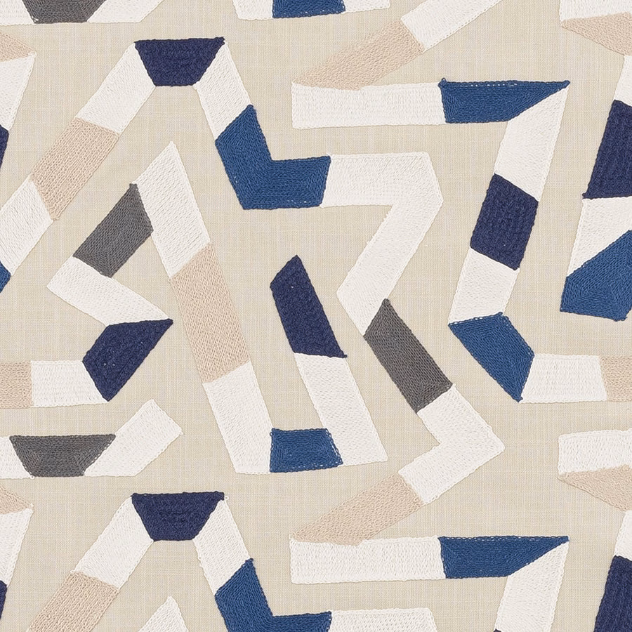 Geometric woven fabric swatch in indigo, ivory, grey and blue on a pale ground