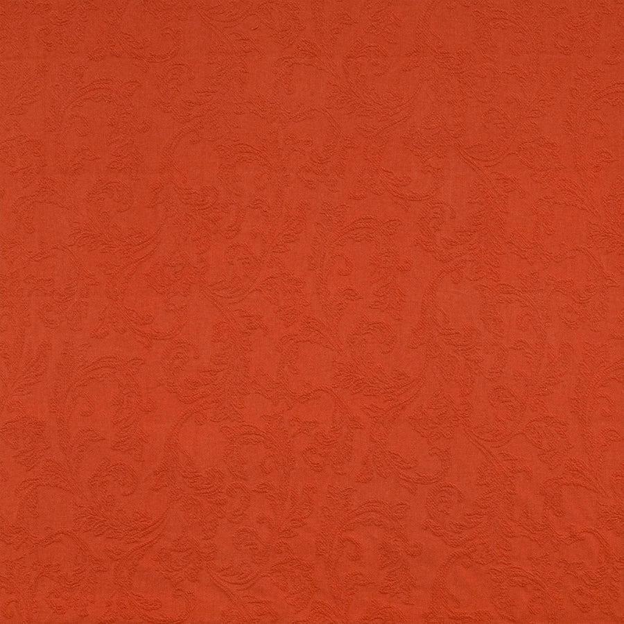 Burnt orange textured fabric with scrolling pattern on a flat swatch