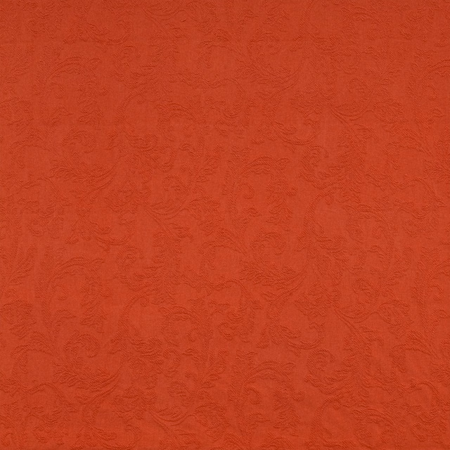 Burnt orange textured fabric with scrolling pattern on a flat swatch