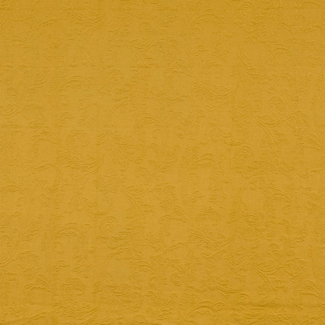 Muted mustard-gold textured fabric with embossed scrolling pattern