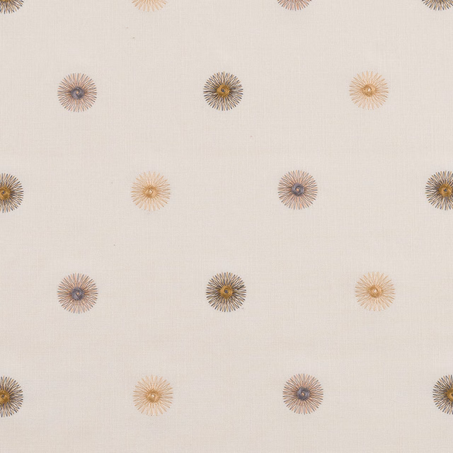 Cream fabric with small scattered embroidered floral rosettes in gold, taupe and blue