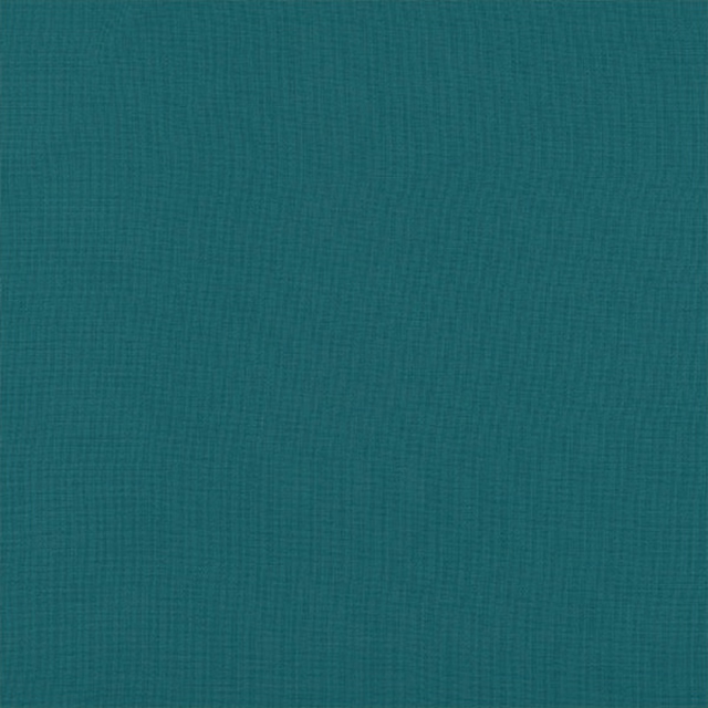 Close-up of plain jade teal woven fabric with fine textured surface