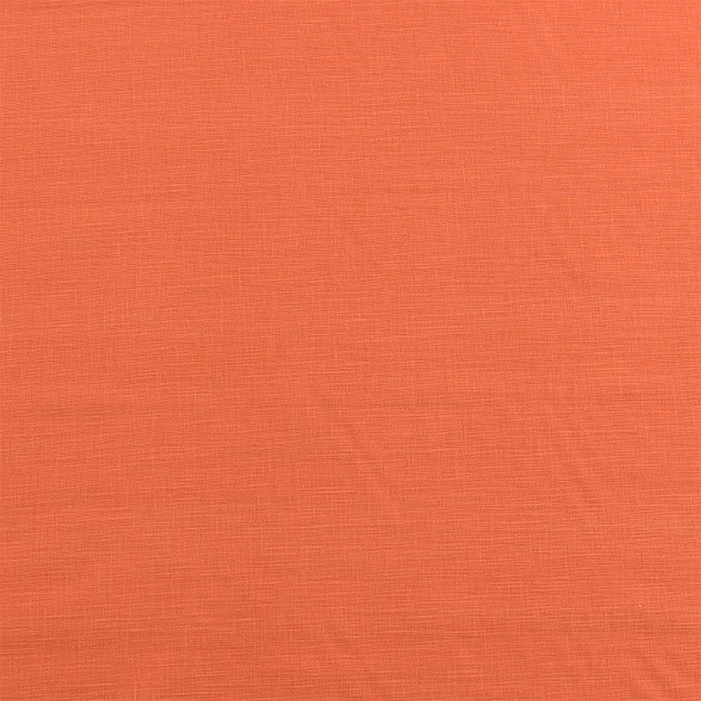 Plain burnt orange cotton fabric with a fine slubbed weave