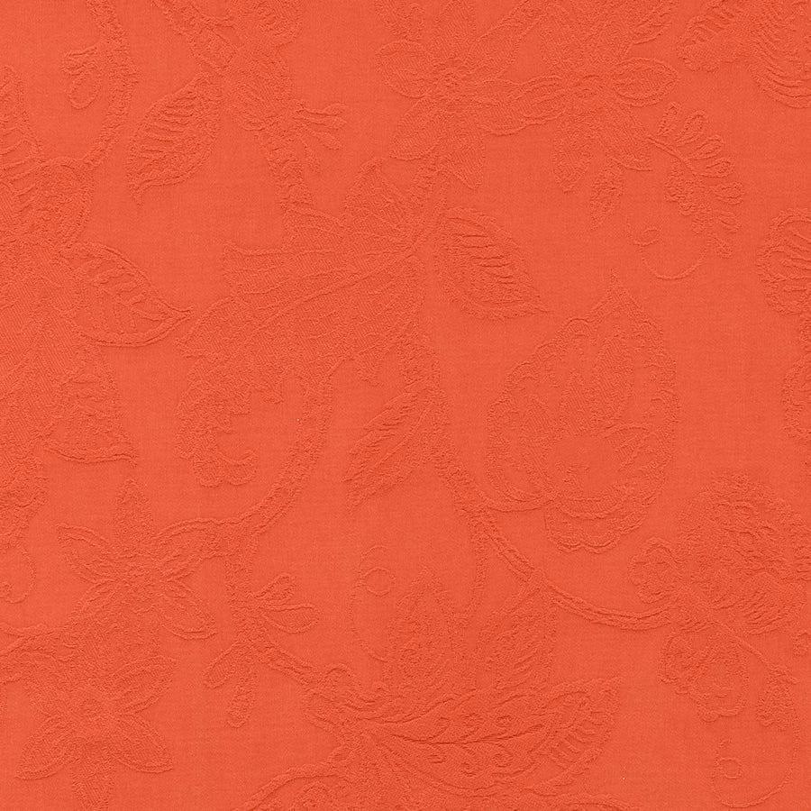 Coral orange floral jacquard fabric with raised textured leaves and vines