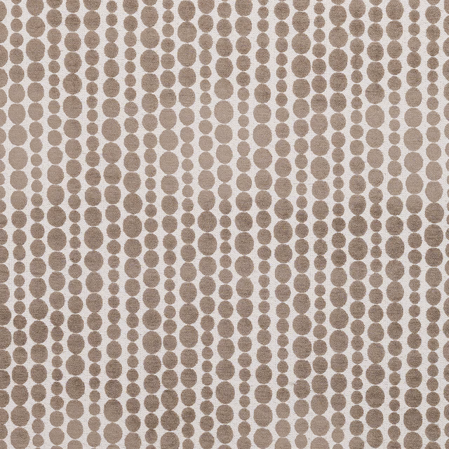 Taupe oval-dot geometric fabric on a pale woven ground