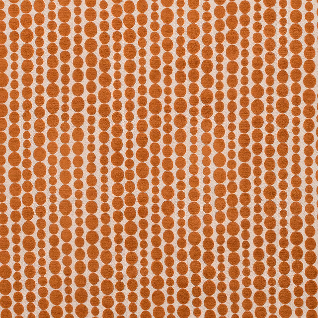 Burnt spice dot pattern on a pale cream woven fabric swatch