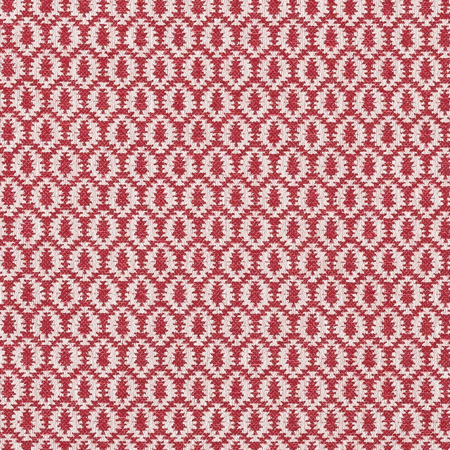 Close-up of red and pale geometric woven fabric with small repeating motif