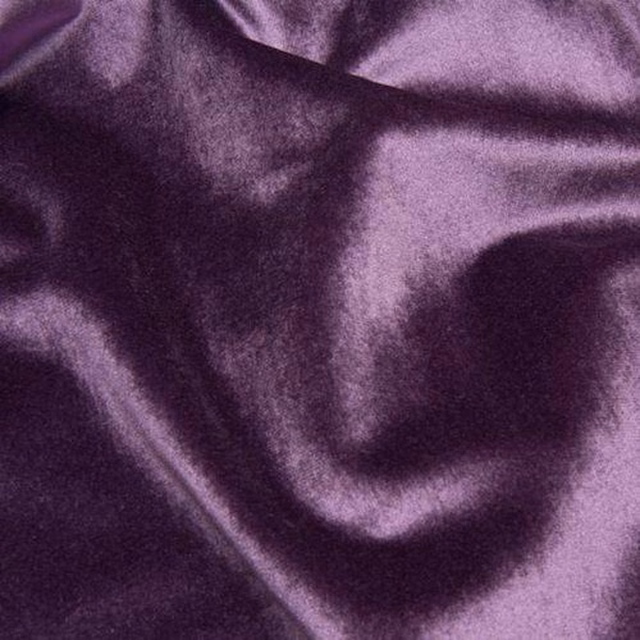 Shimmering aubergine purple fabric with a soft velvety drape and dark folds