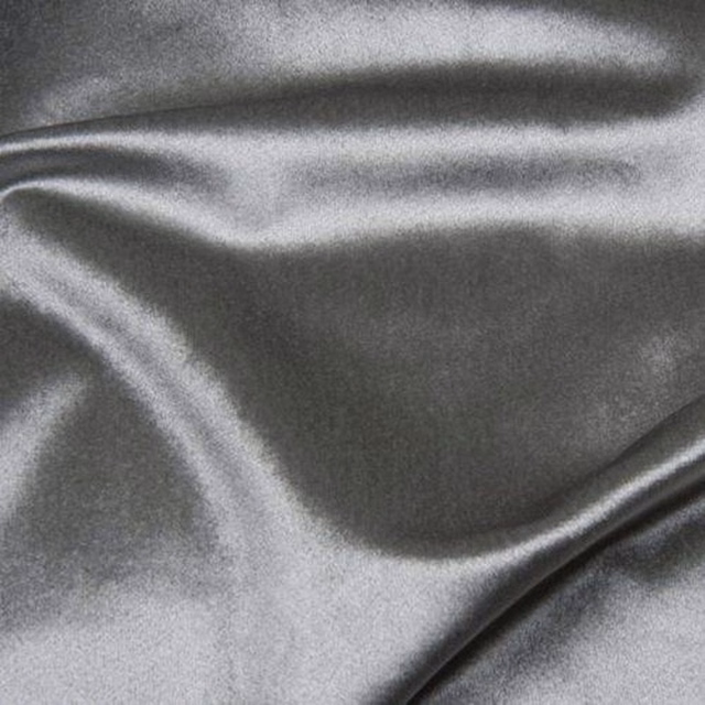 Cool dove grey satin fabric with soft rippling folds and a smooth sheen