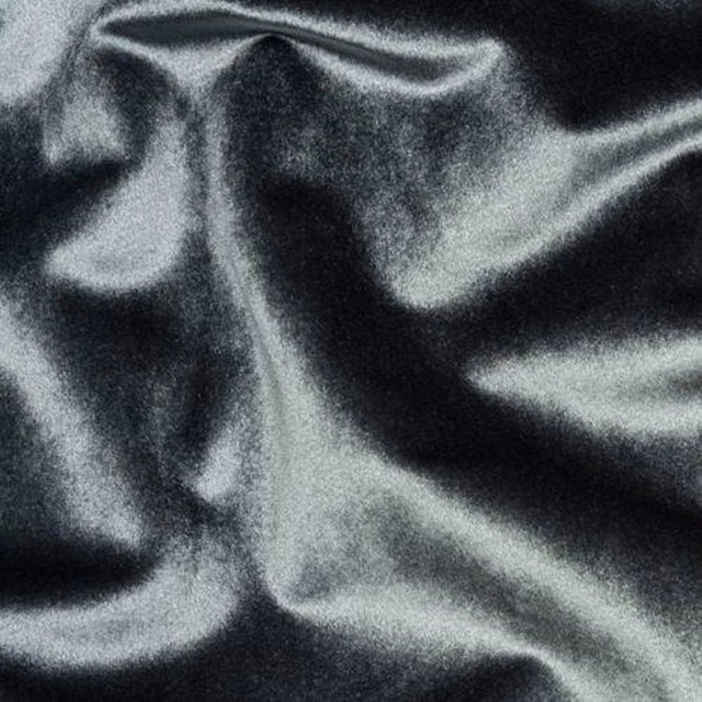 Close-up of deep smoky grey fabric with a smooth, lustrous sheen and soft folds